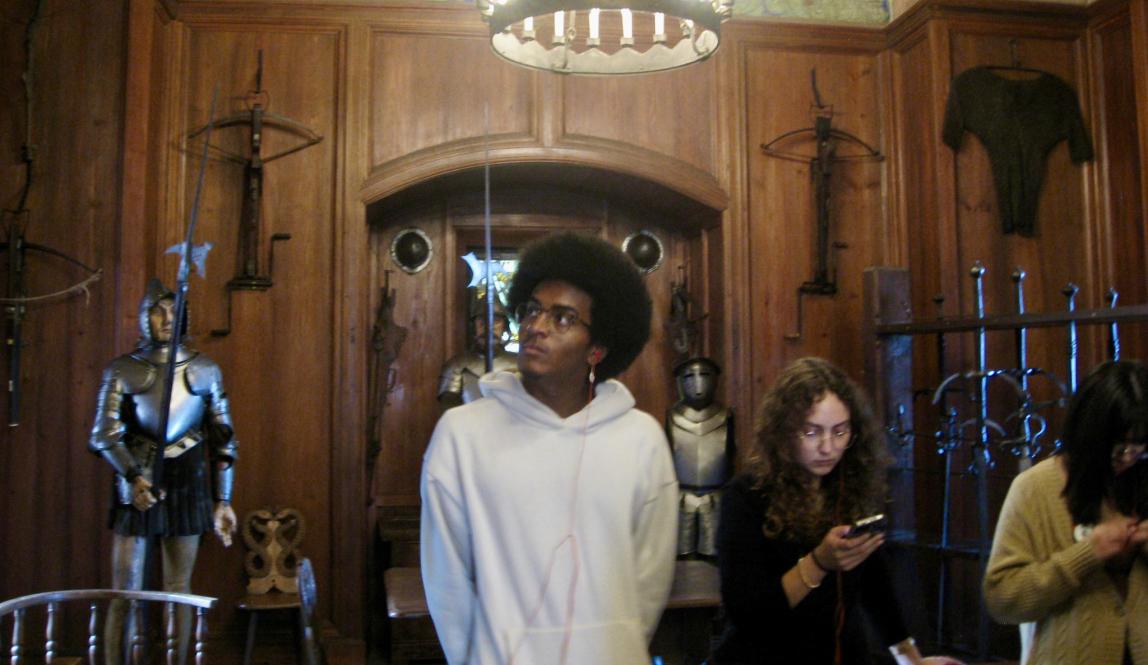 Person standing around medieval armor