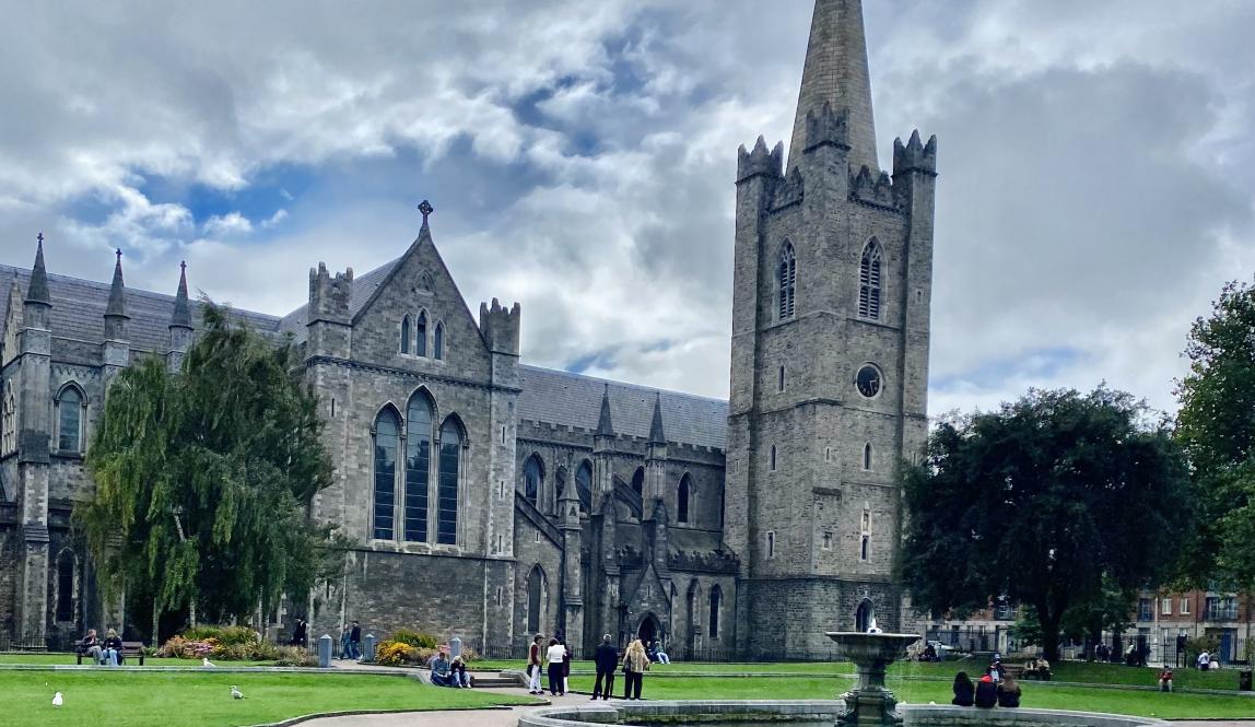 A photo of the fountain and lawn in St. Patrick’s Park with St. Patrick’s Cathedral in the background.