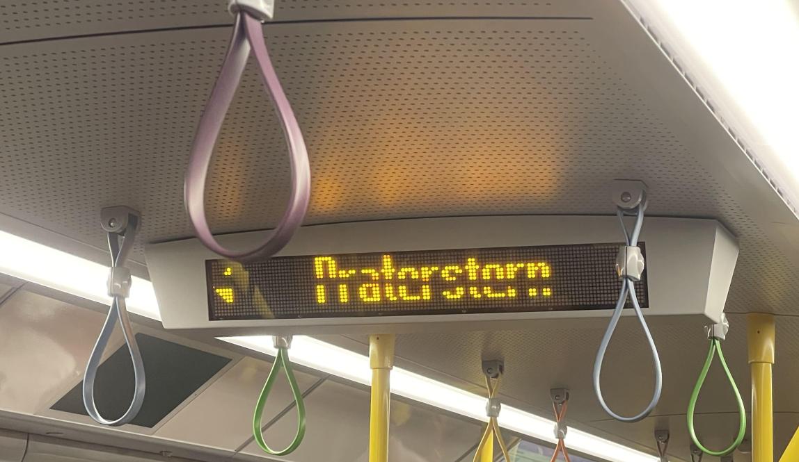 Digital signage on subway showing which station is next, and which side to leave from