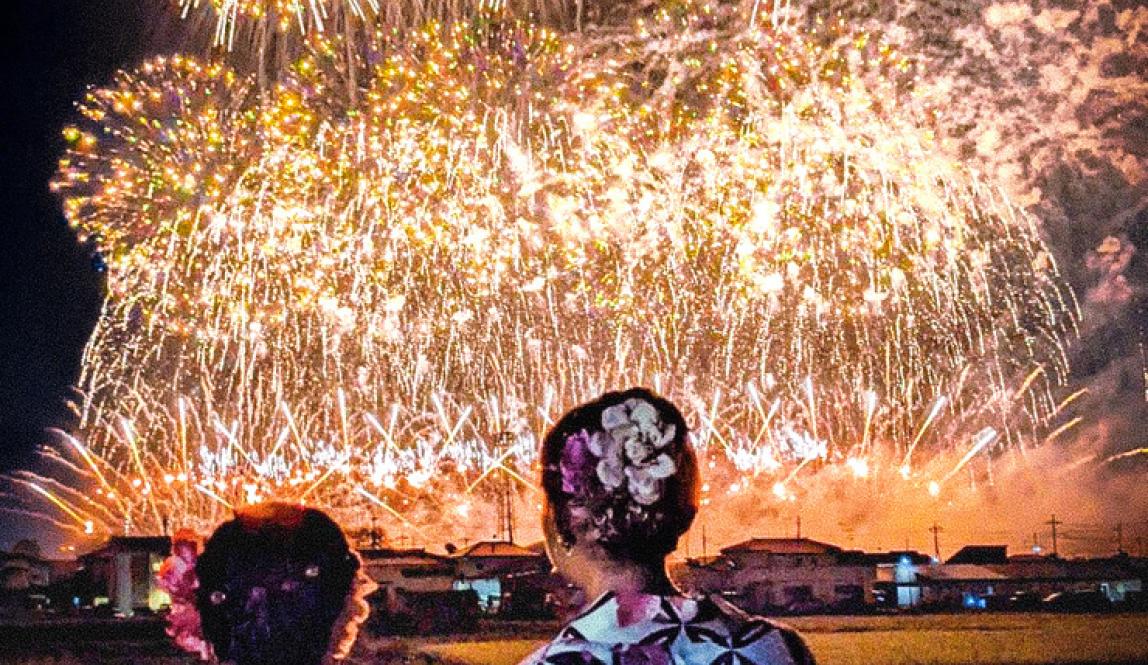 Tokyo Tonegawa Fireworks with two students standing in front of them
