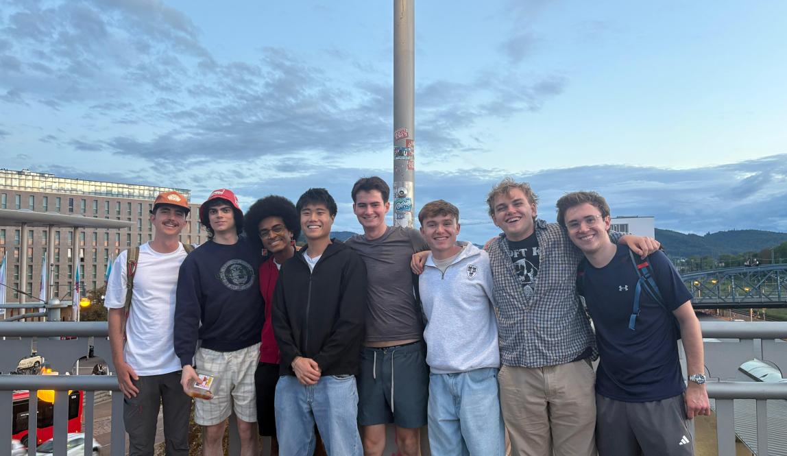A group of people posing for a picture on a bridge