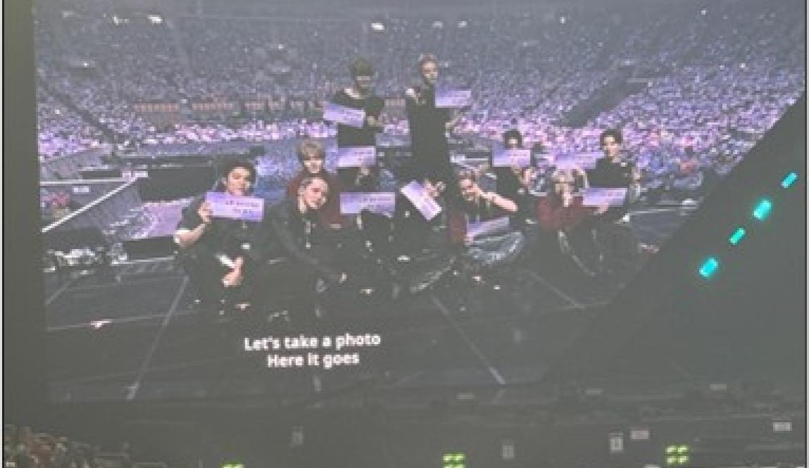 Treasure taking a picture with fans.