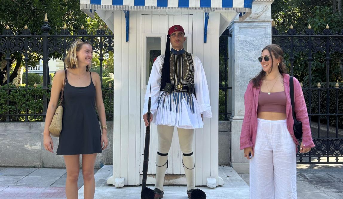 Female students posing with guard in Athens, Greece