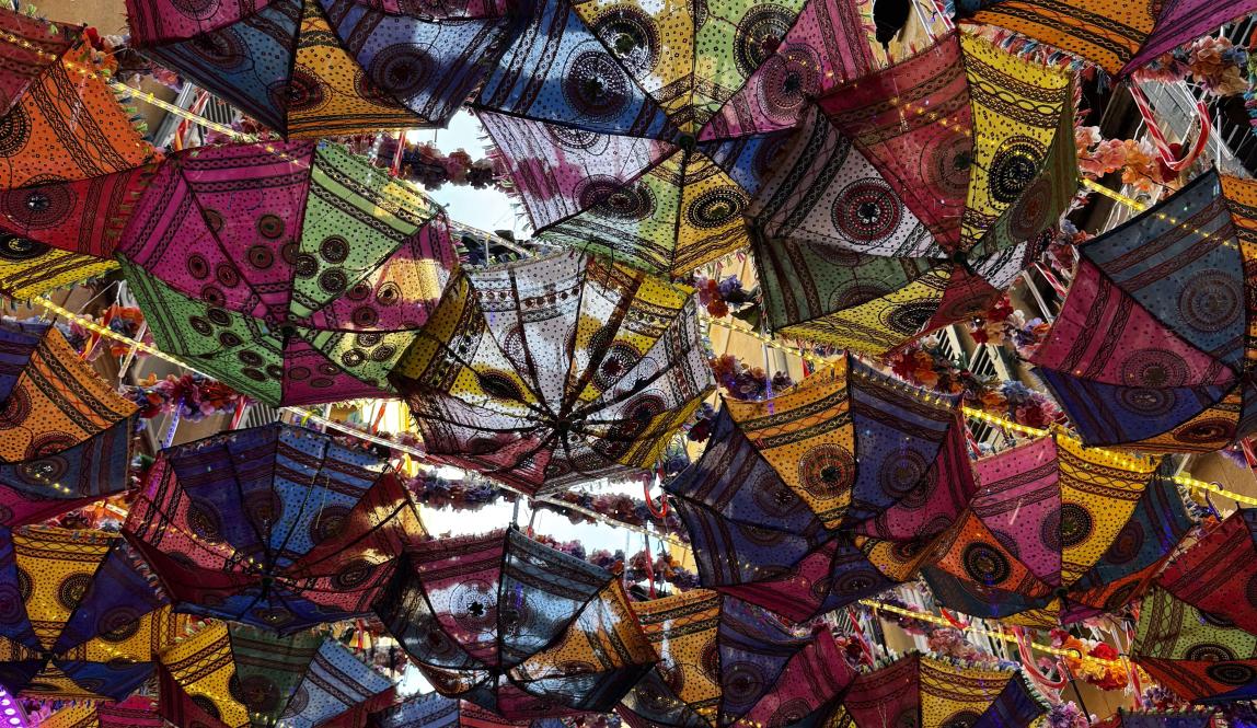 Mini Umbrellas hanging from buildings