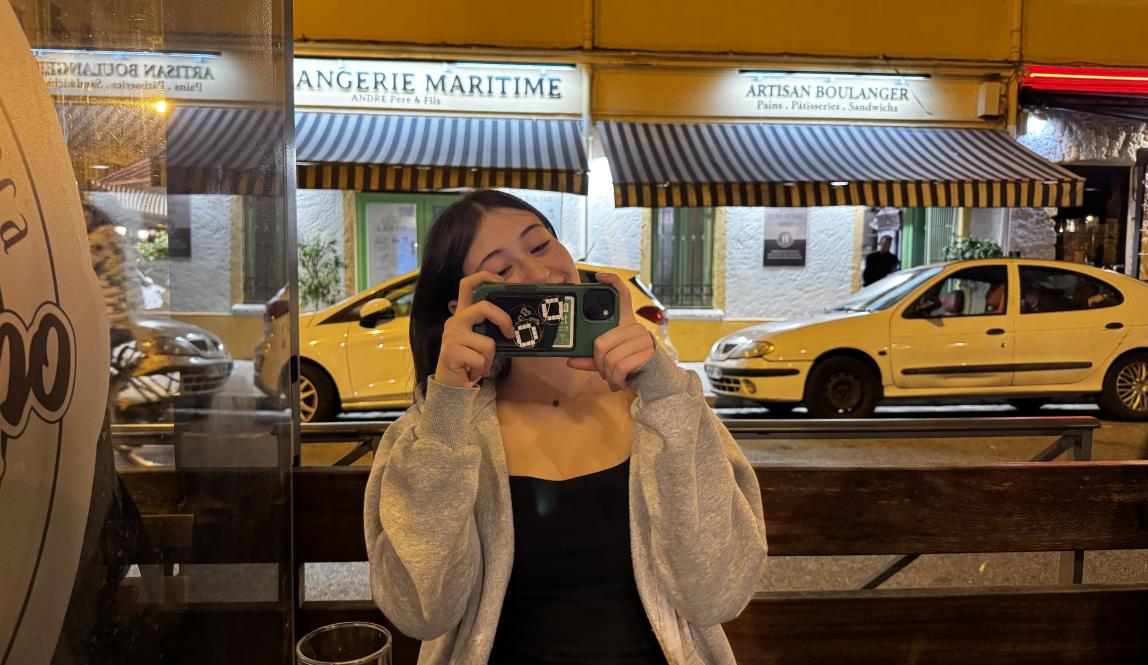 Woman holding up phone to take a photo