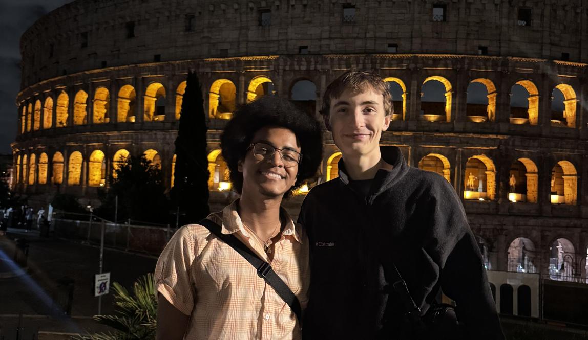 Two people in front of the Colosseum