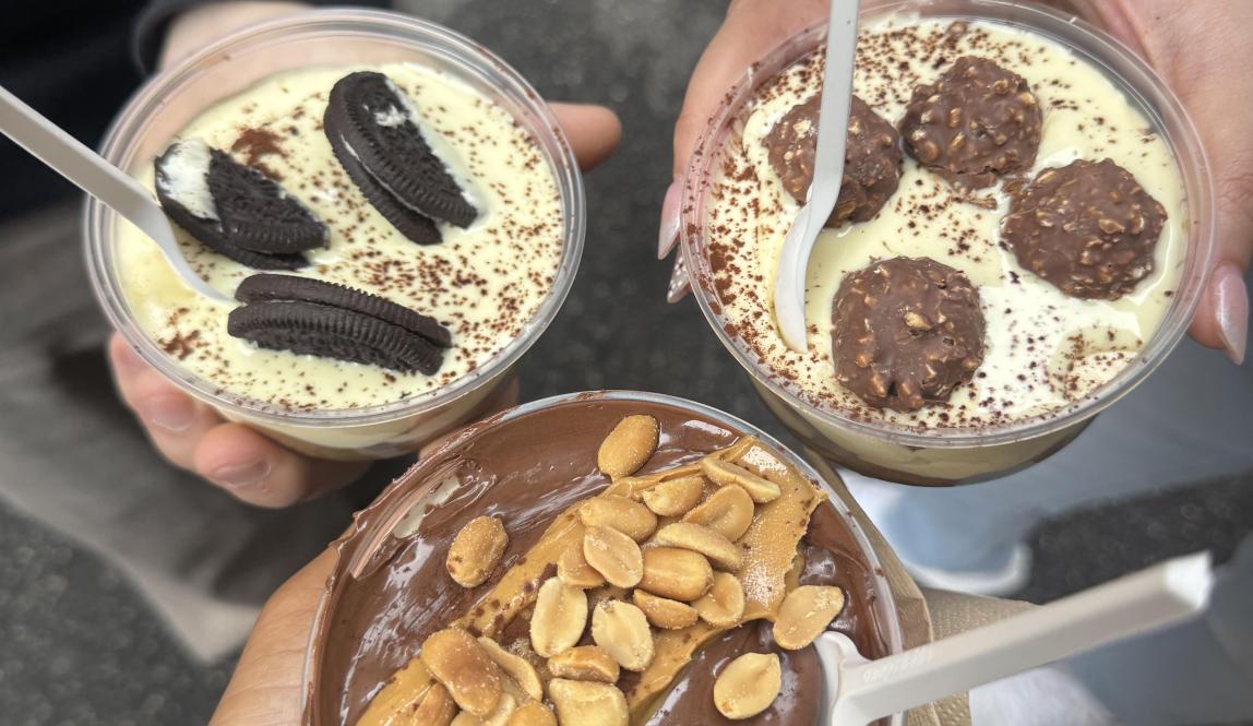 Three people holding tiramisu