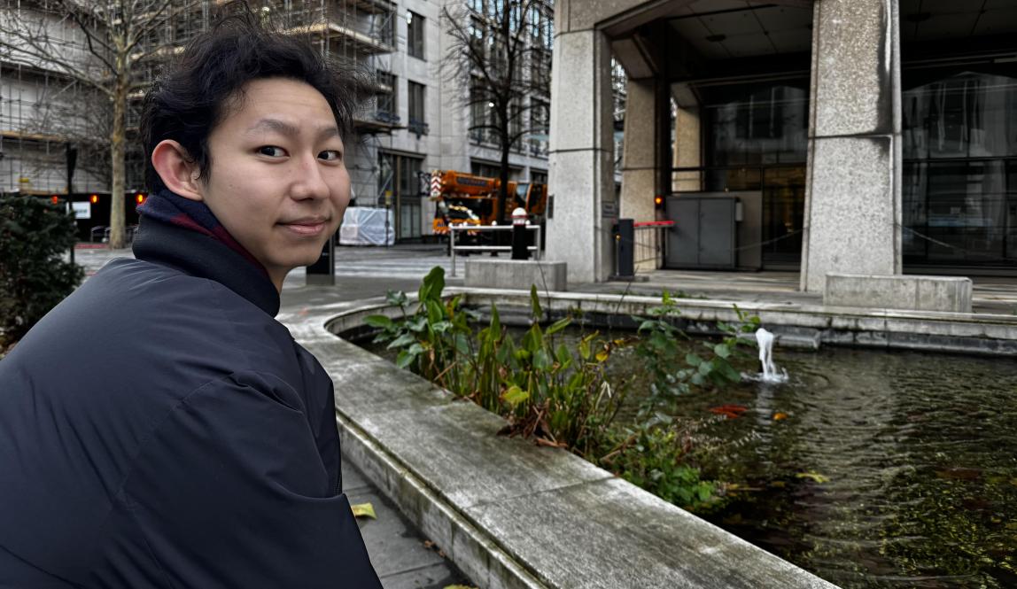 Man posing for a photo with a scenic background