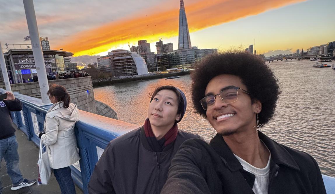 Two people posing with the sunset