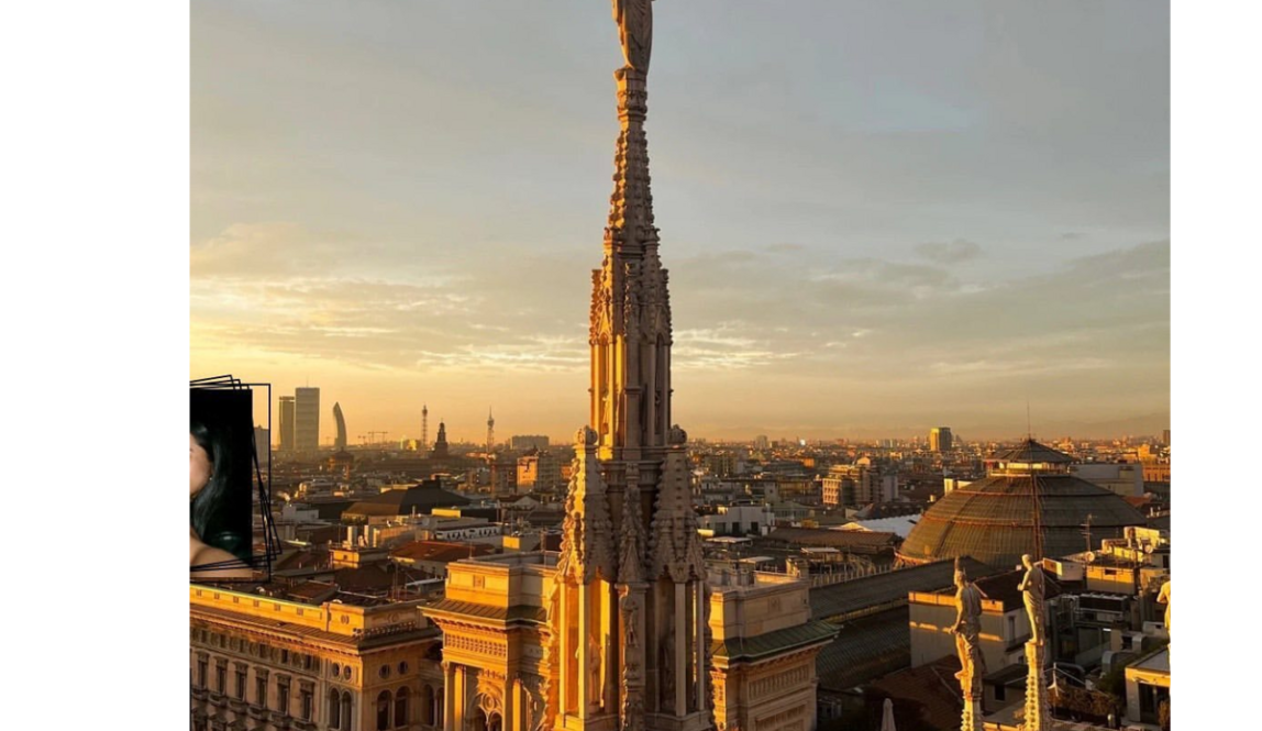 Golden sunset view from the top of the Duomo in Milan, with detailed stone spires glowing in the golden light and the city skyline in the background