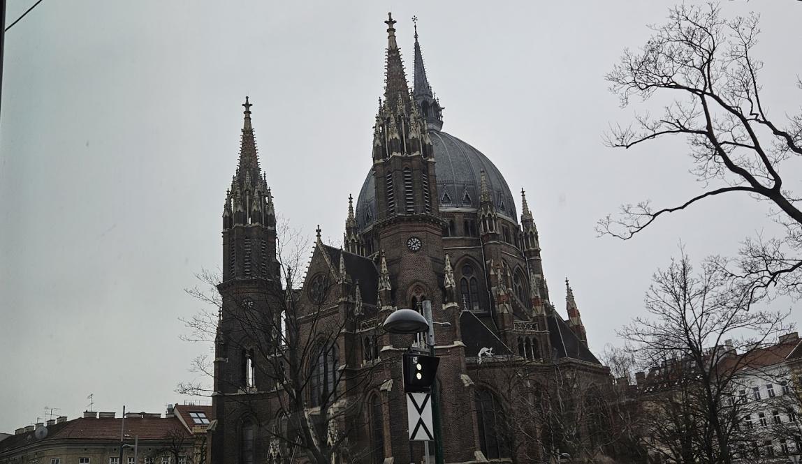 A photo of Vienna's Maria vom Siege, with gray skies and winter trees.