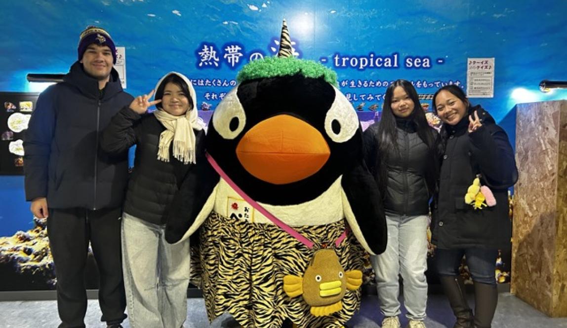 My friend and I posing with the Otaru Aquarium mascot which is a penguin