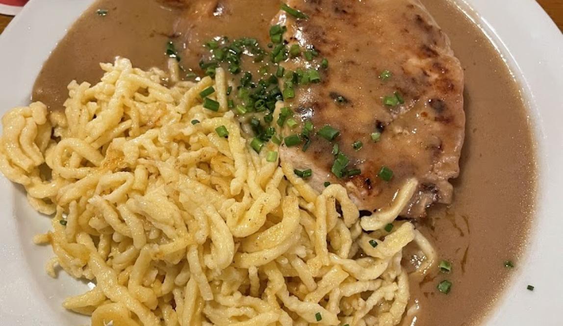 A plate of schnitzel and spaetzle