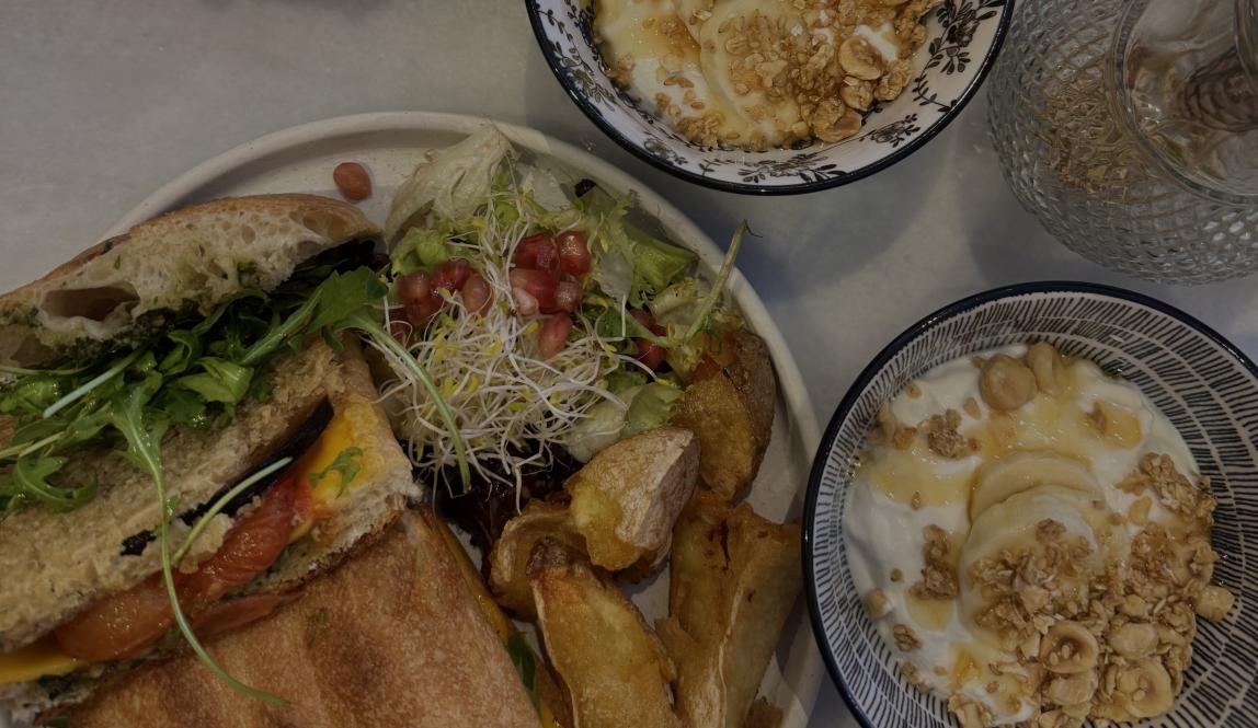 Super Eggplant Sandwich next to two bowls of yogurt with granola from Marmot Cafe.