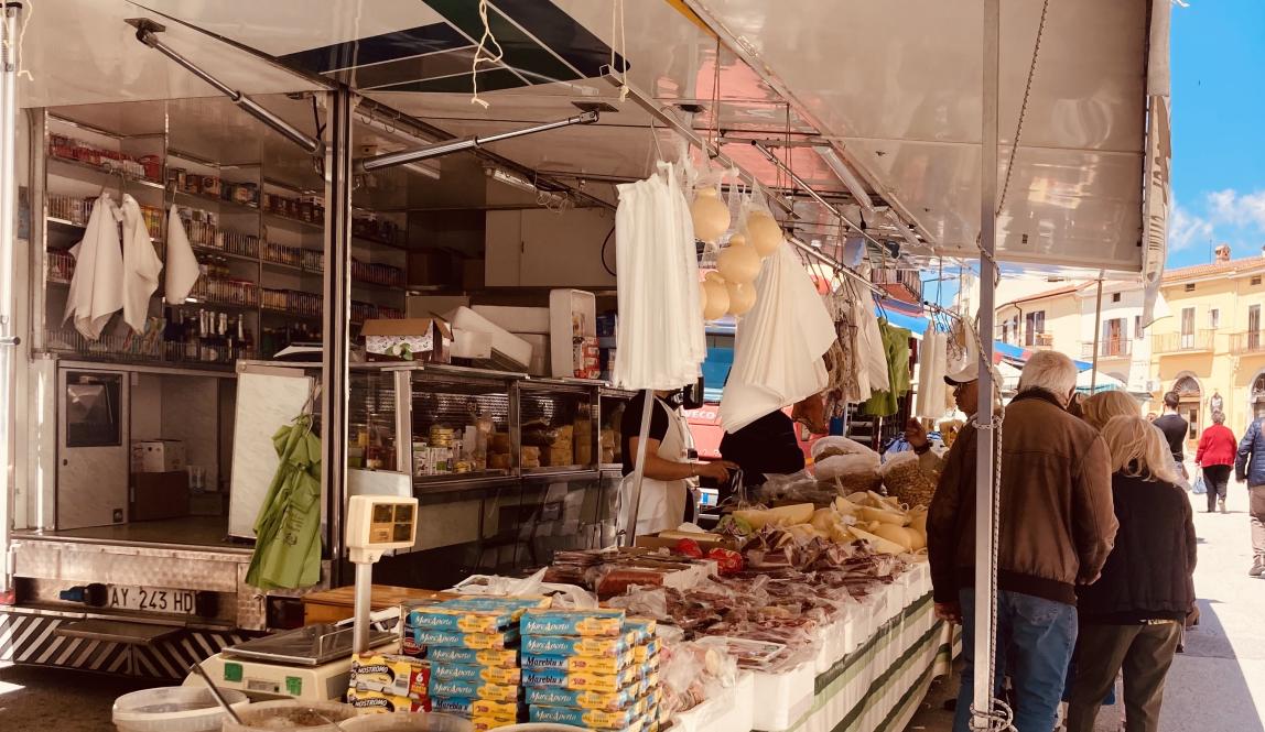 Stalls selling meats, cheeses and nuts in the Calitri market