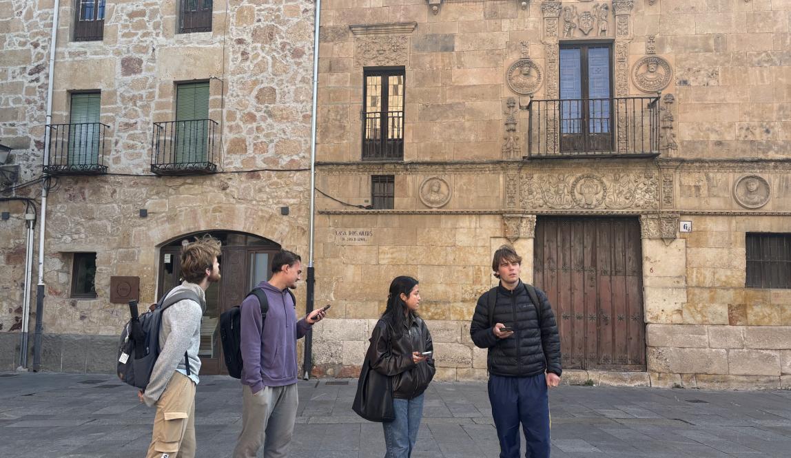 Four students look around on the streets of Salamanca, Spain.