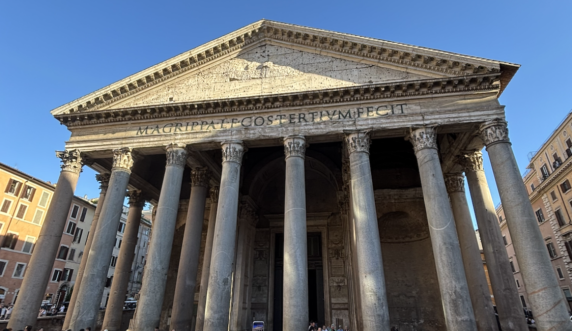 A frontal view of the Pantheon with tourists in the foreground