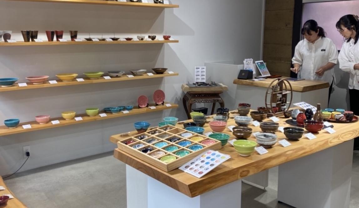 A ceramic shop with many colorful plates and cups.