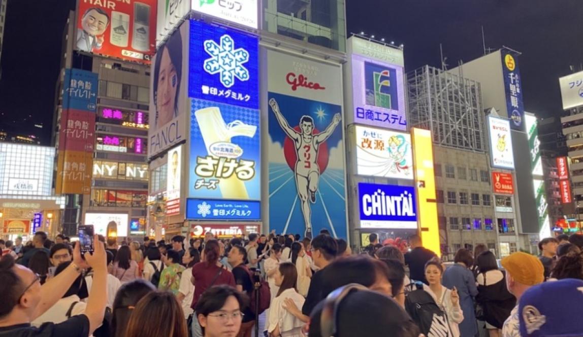 An image full of people crossing the Ebisu Bridge in Osaka.