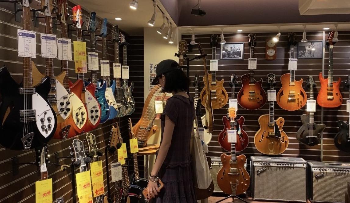 A friend of mine looking at very decorative guitars.
