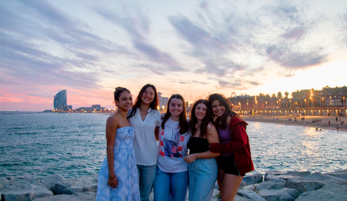 Friends soaking up the sunset on a trip to Barcelona, Spain