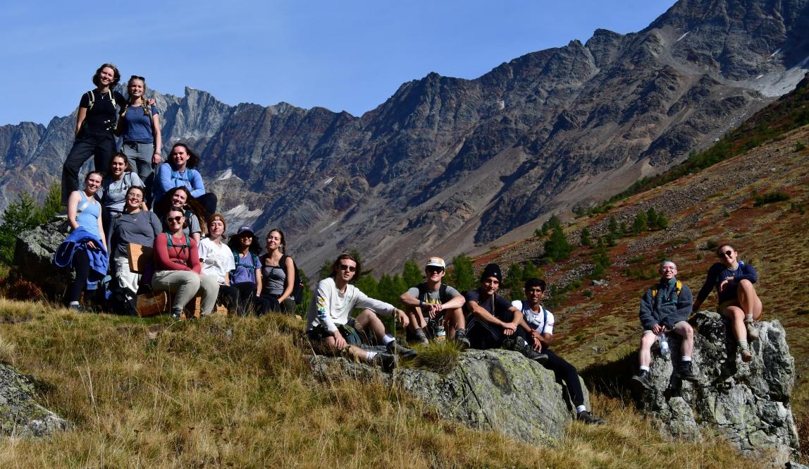Students hike in the Alps on a sunny day with their classmates on a field trip from Freiburg, Germany.