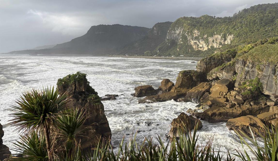 A view of rocks lining the coast of the strong West Coast waves.