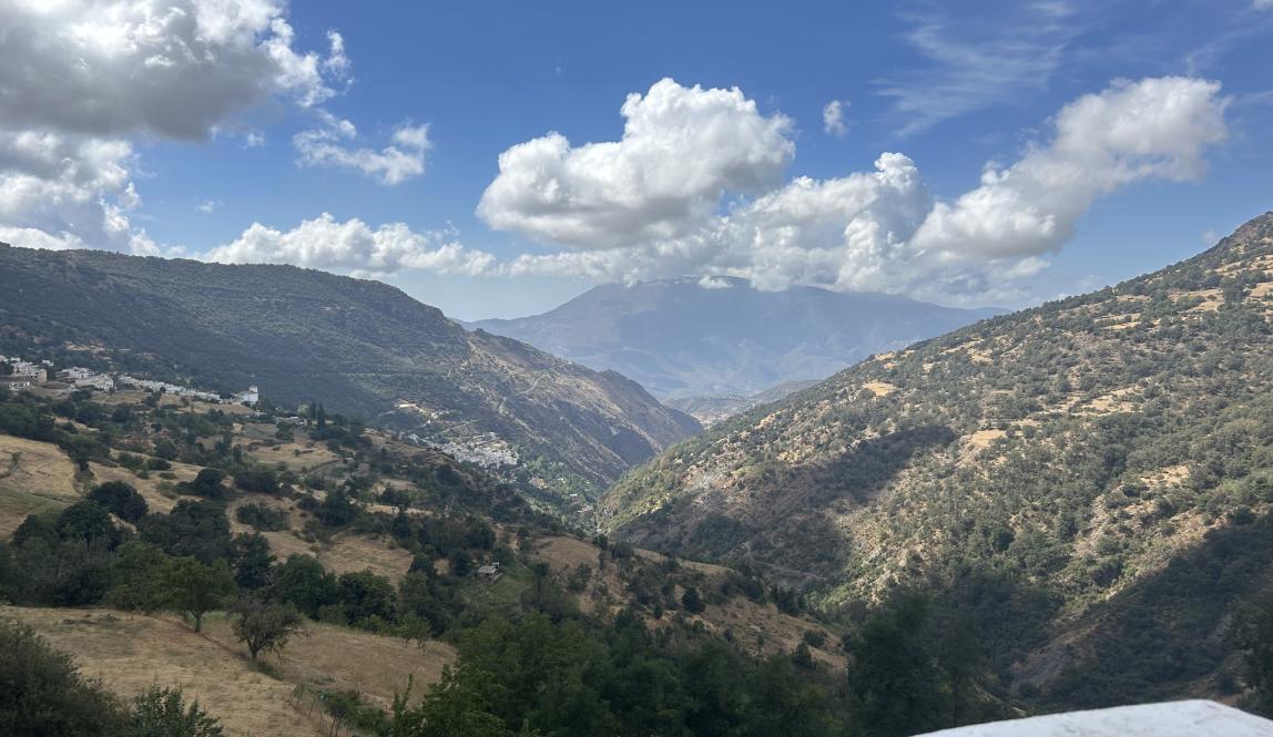 Green mountains on either side of the mountain form a valley in the middle