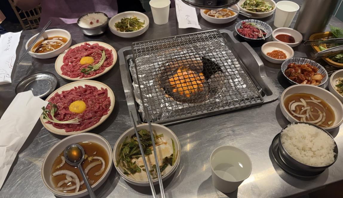 Table spread of a korean barbecue dinner.