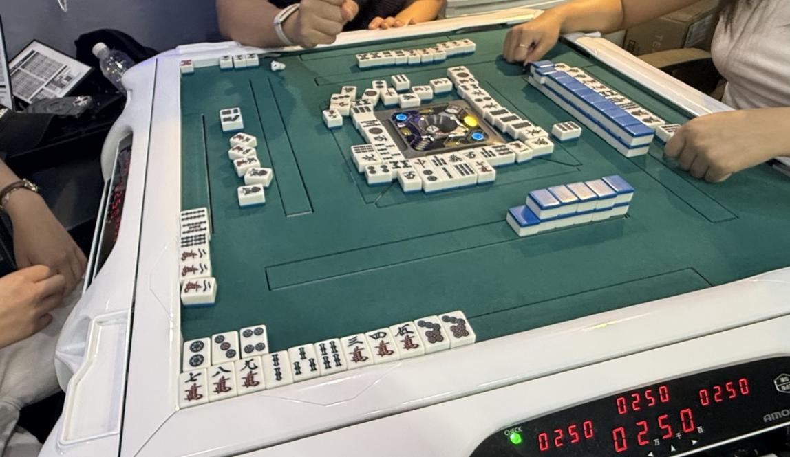 A game of mahjong at a board game cafe.  