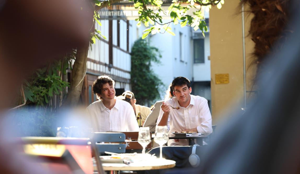 Two students eat in the garden at IES Abroad Freiburg for the student goodbye dinner.