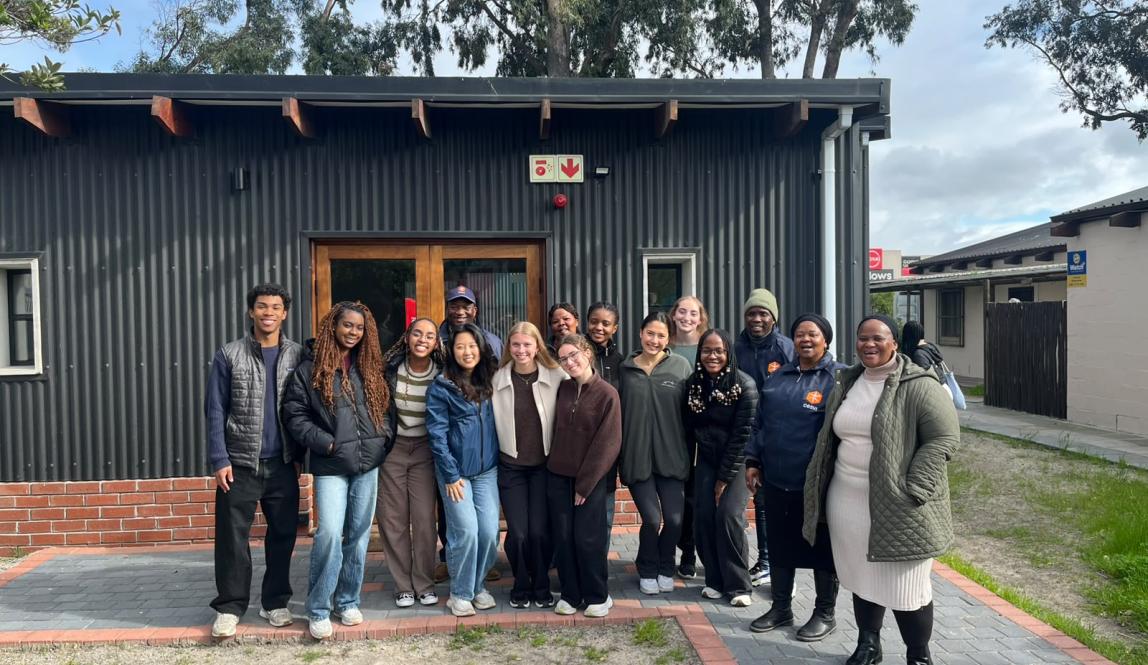 Students studying health in Cape Town stand as a group in front of building