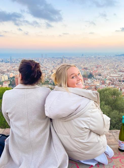students sit at the Bunkers in Barcelona watching the sun set