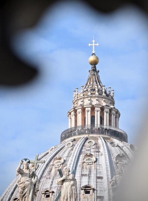 a cross atop a dome at the Vatican
