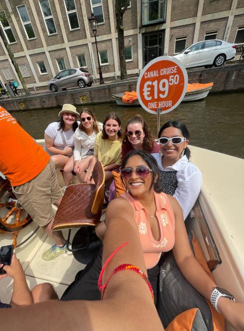 six girls pose for a photo on a canal tour of Amsterdam