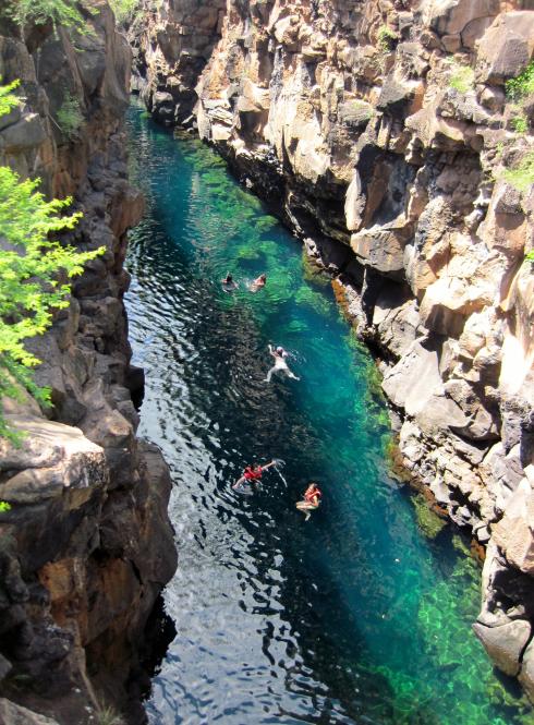 students swimming in Las Grietas on Isla San Santa Cruz
