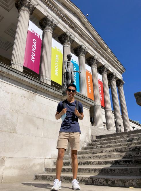a student standing on the steps of University College London