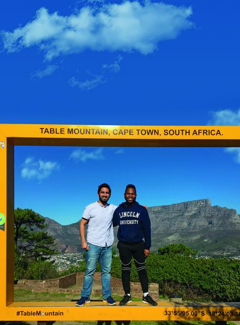 Two Internship students standing in front of Table Mountain in Cape Town