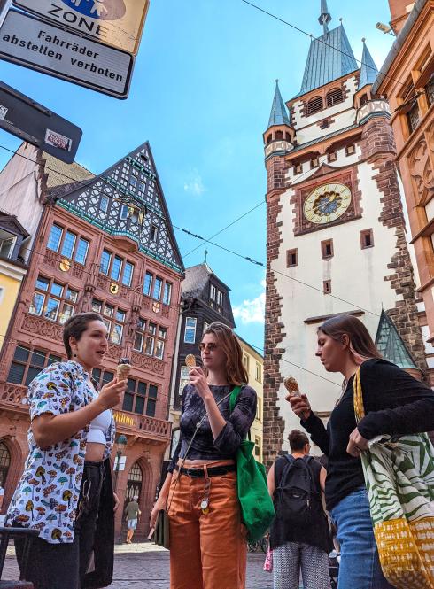 students standing eating ice cream surrounded by German architecture