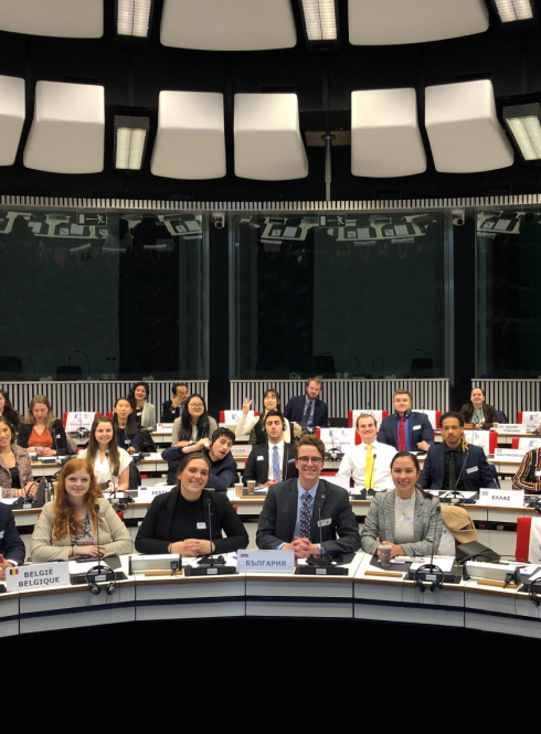 Students sit in three rows and look at the camera as they take part in a Model EU 