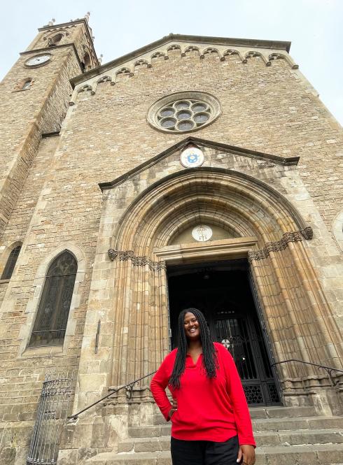 an IES Intern standing in front of her internship placement at a typical European building