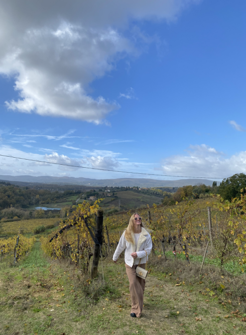 A student walks through a Tuscan landscape