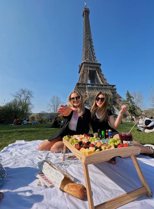 Two students having a picnic at the Eiffel Tower in Paris, France