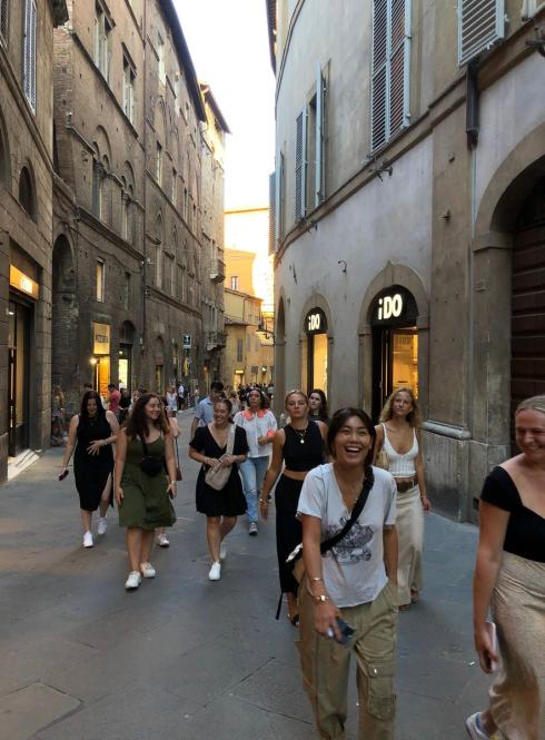 Students walking down the streets of downtown Siena during orientation