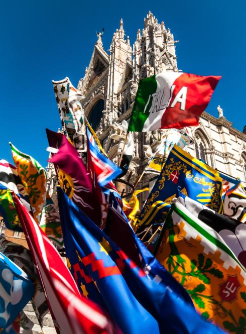 Flags for sale in front of the Duomo di Siena