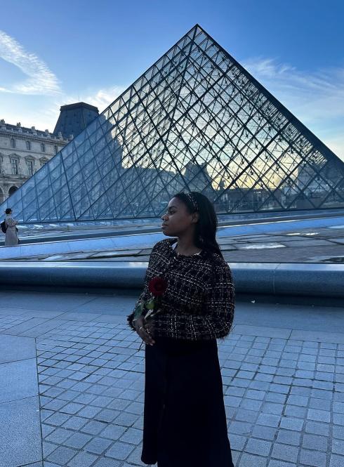 Student in front of Louvre Pyramid in Paris, France