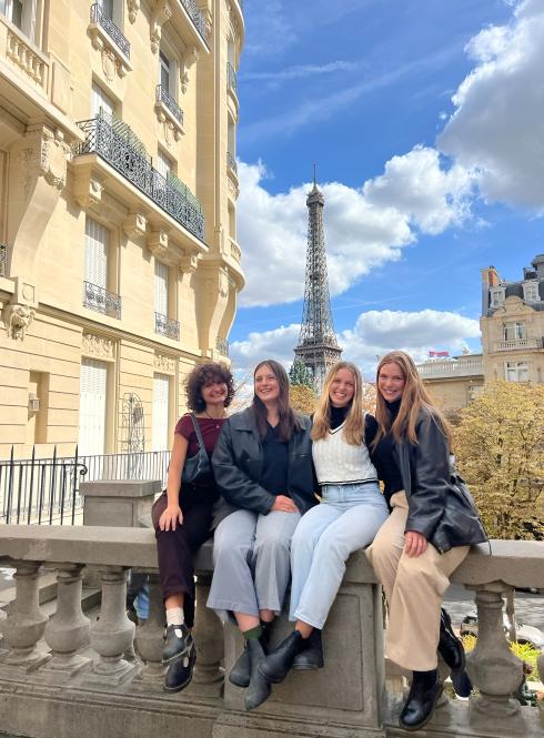 Four students at viewpoint in Nice, France - posing with city and ocean behind them 