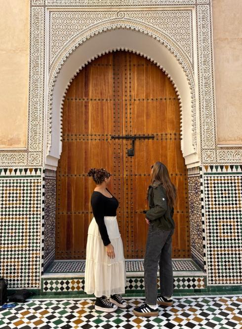Two Female Students in Rabat's Medina Looking Upwards