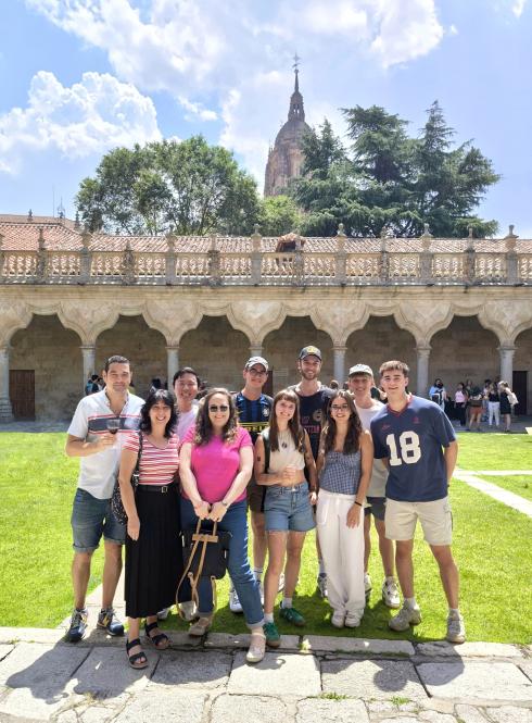 A Group of Students and their teacher in the IES Abroad commons on a sunny day.