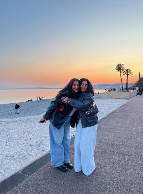 two students hugging on Nice beach at sunset